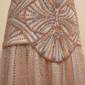 Close-up of a couture inspired luxury fashion beaded and sequined dress fabric with intricate patterns.