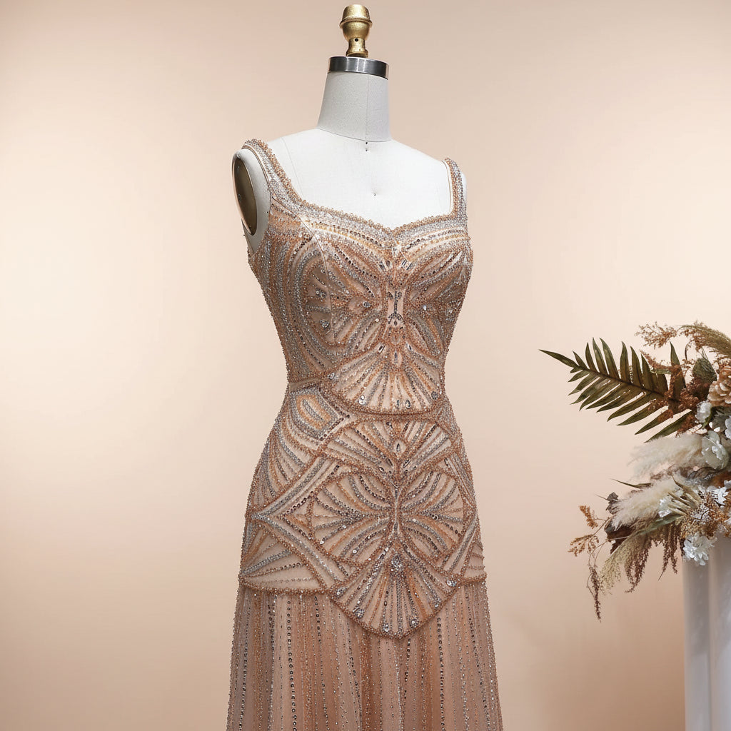 Luxurious Elegant golden champagne beaded evening gown on a mannequin against a light background