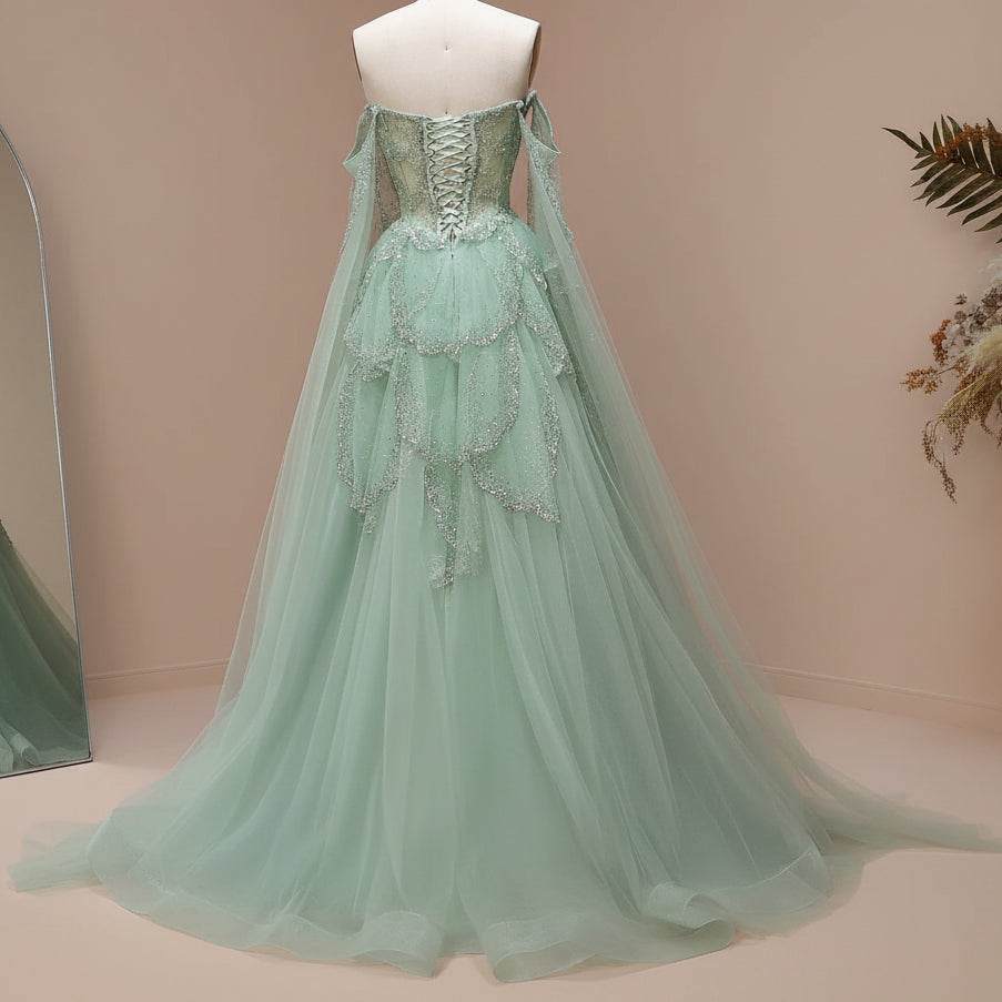 Luxury mint green princess ballgown,  on a mannequin against a light background, corset style lace up back