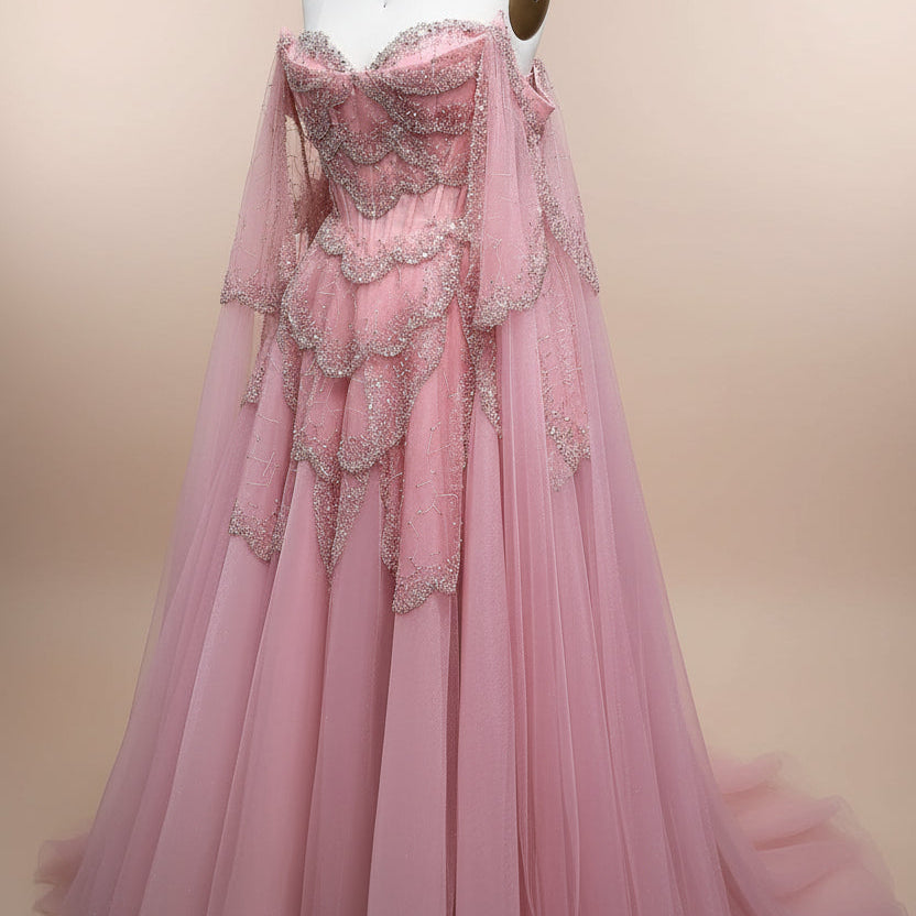 Stunning blush Pink evening gown with intricate shiny detailing on a mannequin against a light background