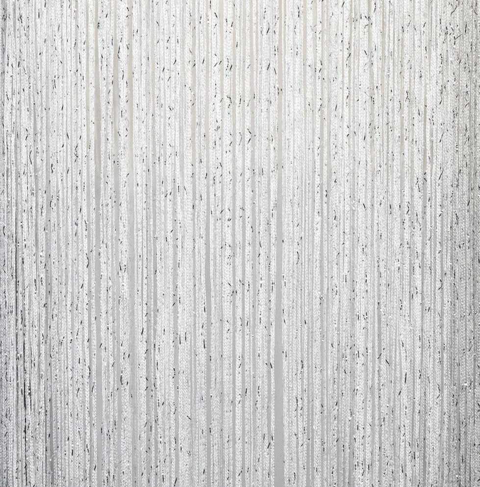 Close-up of shimmering tassel fringe details of a luxury white evening gown