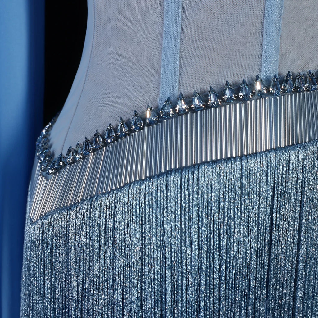 Close-up of a luxury fashion blue evening gown with crystal embellishments on a dark background