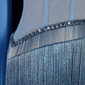 Close-up of a luxury fashion blue evening gown with crystal embellishments on a dark background