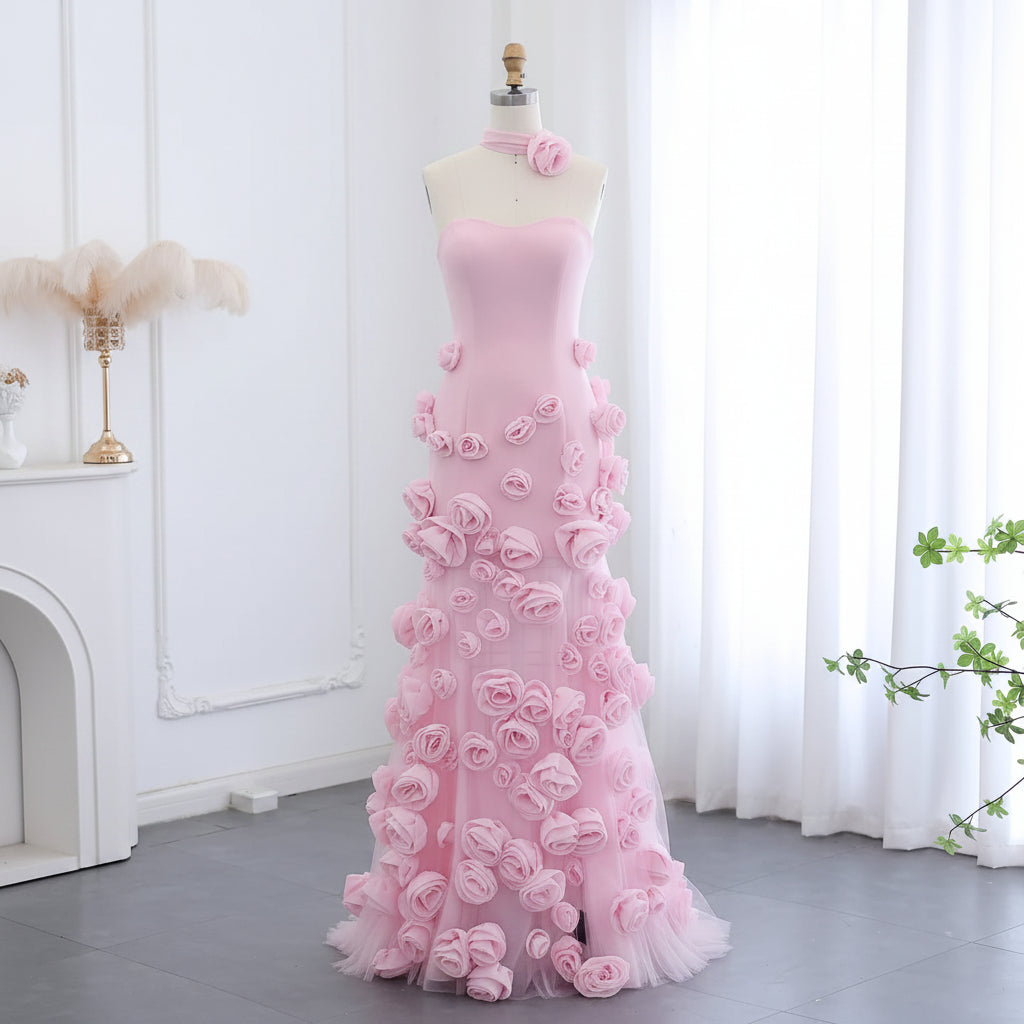 Luxury Pink evening gown with floral details on a mannequin against a white curtain background.