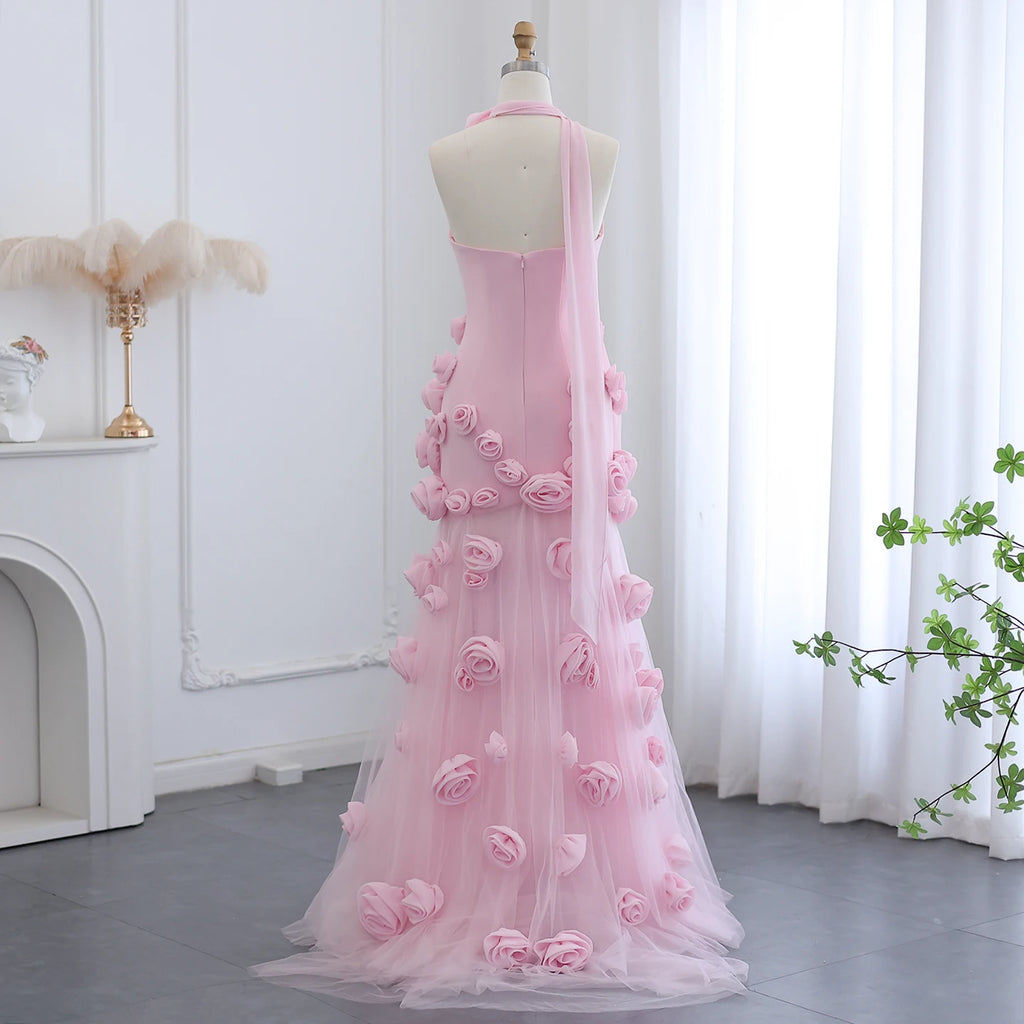 Couture Pink evening gown with floral details on a mannequin against a white curtain background.