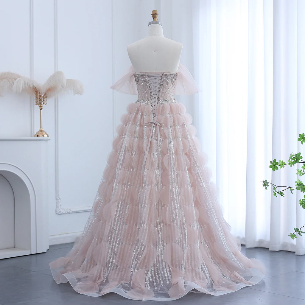 Amazing Pink evening gown with corset style back on a mannequin against a white curtain background