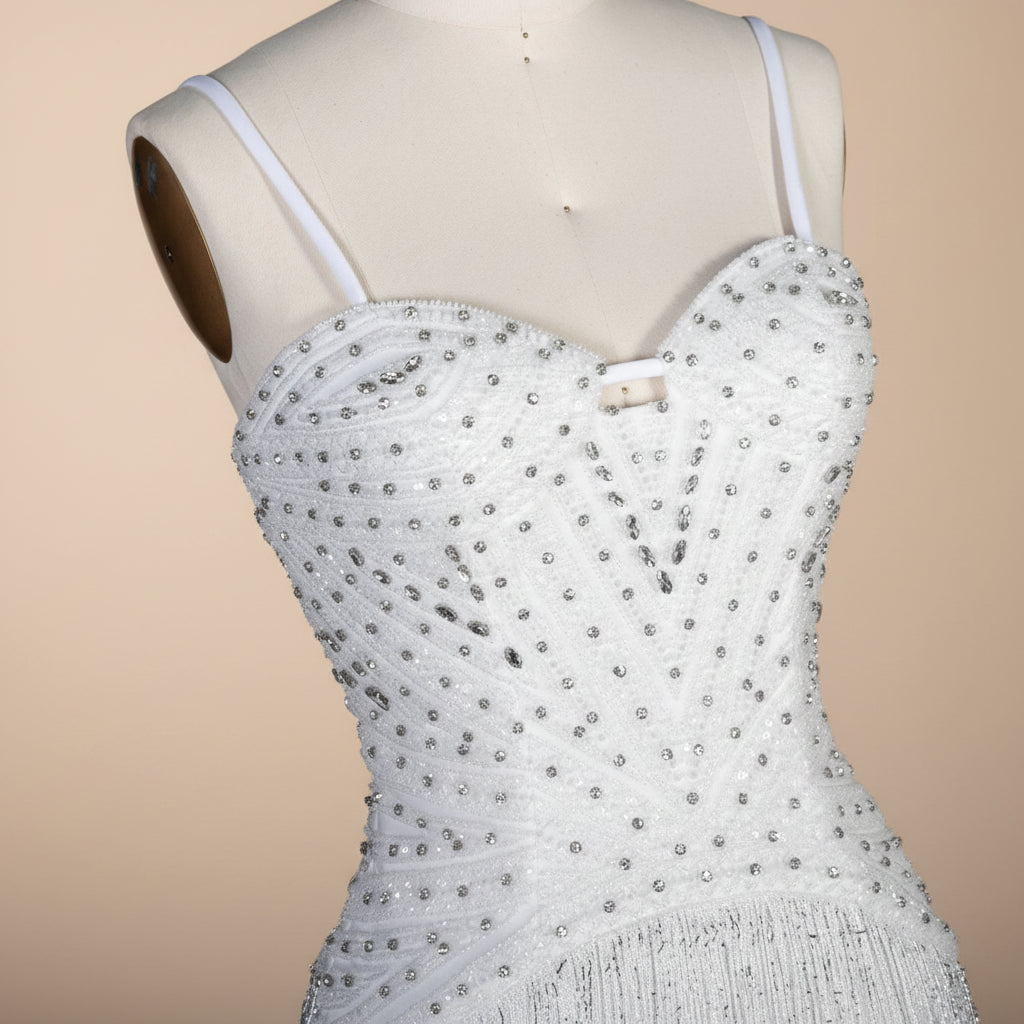 Beautiful rhinestone detailed White beaded luxury fashion dress on a mannequin against a neutral background