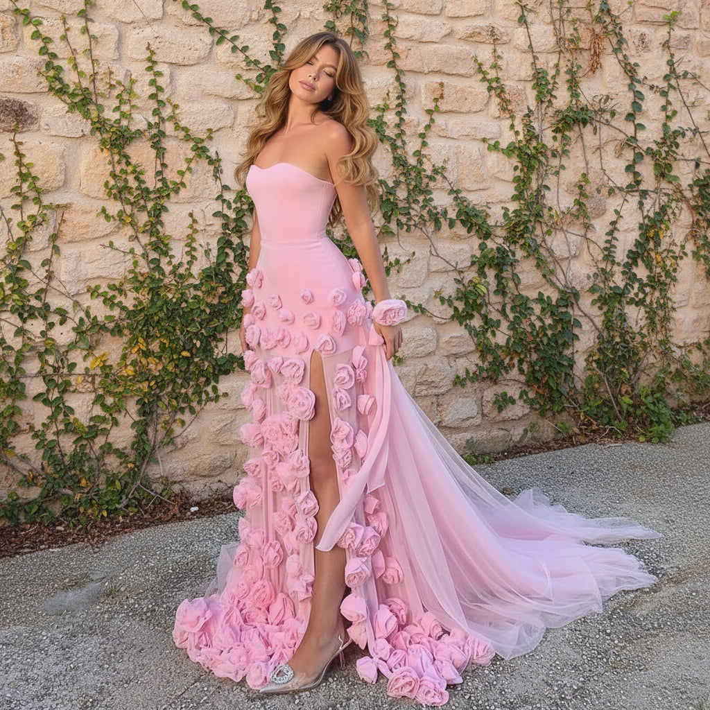 Beautiful Woman in a luxury pink floral embellished evening gown standing outdoors.