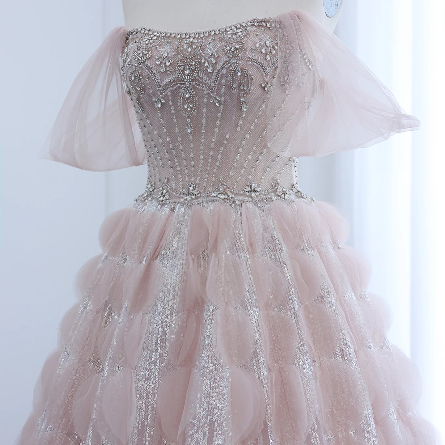 Gorgeous Pink crystal beaded dress on a mannequin against a white background