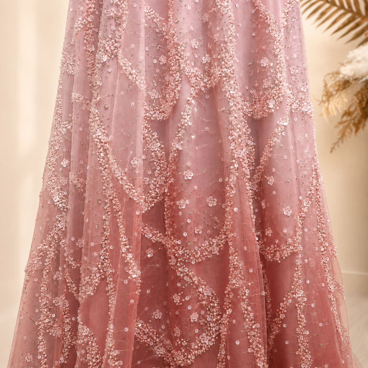 Stunning closeup of the detailed intricate beadwork on a luxury pink prom dress. The fabric is light pink ombre color. 
