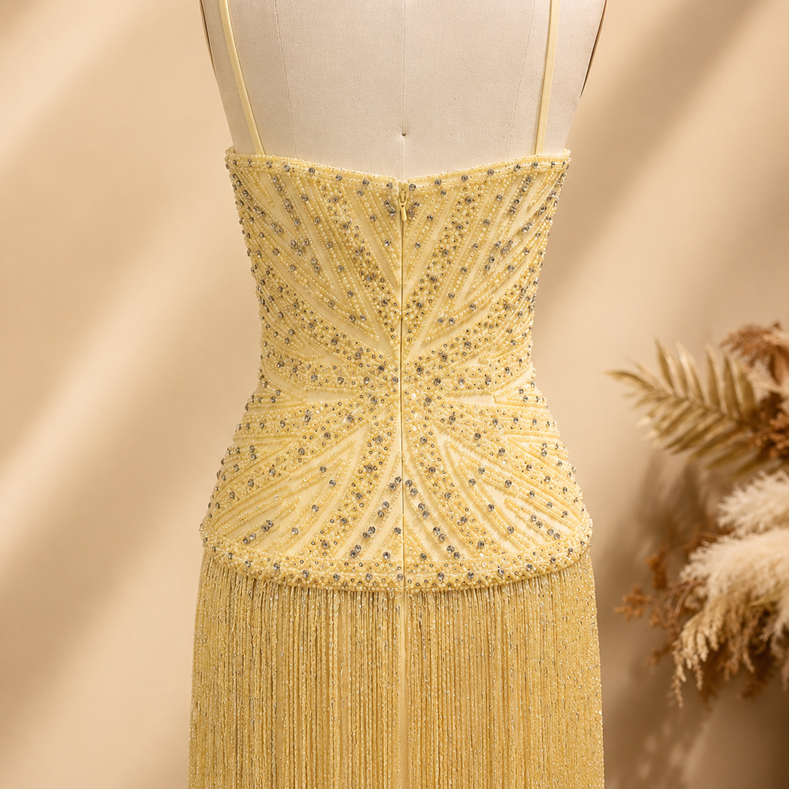 Elegant Yellow shimmering beaded dress on a mannequin with a neutral background