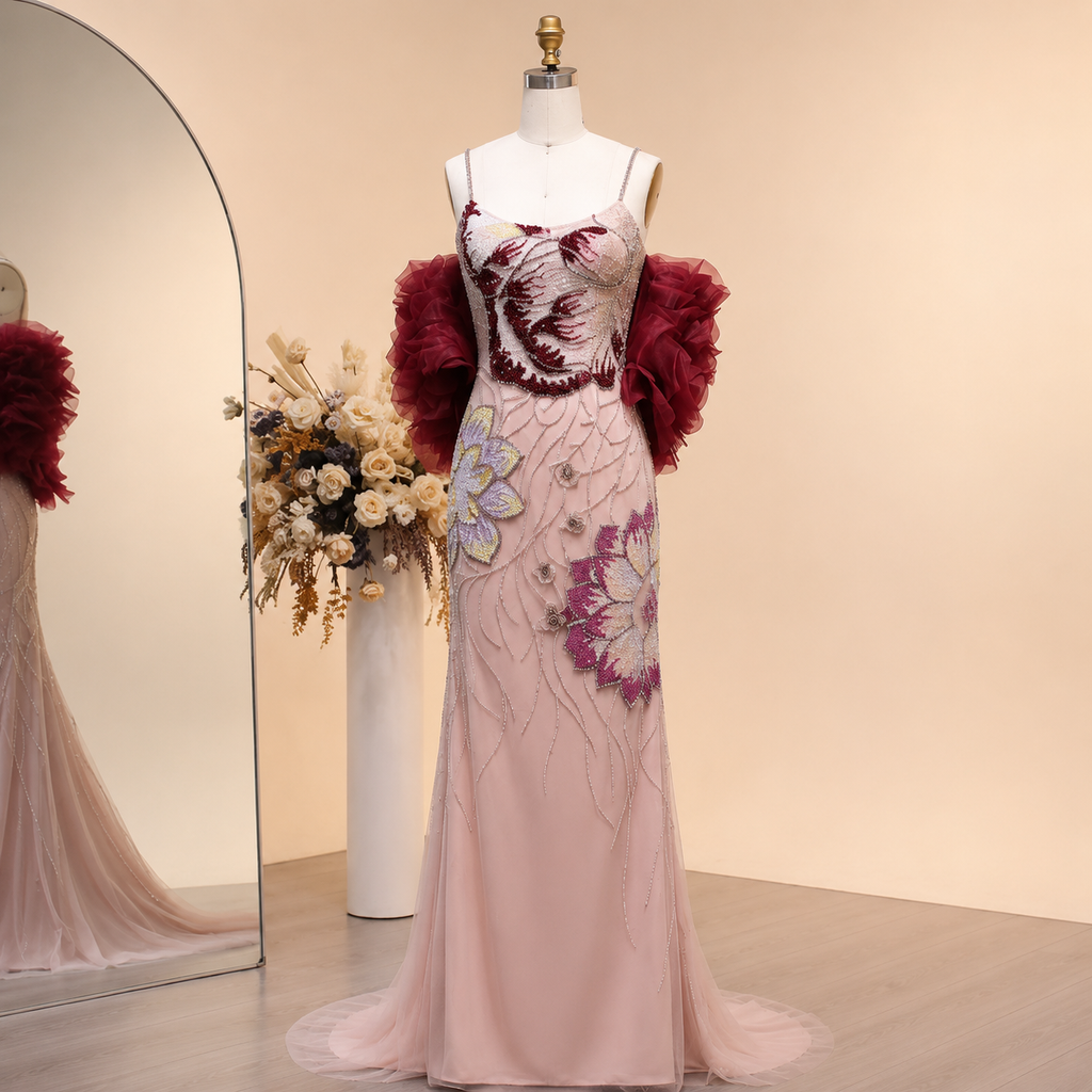 Elegant luxury pink evening prom gown with crystal beaded details on a mannequin against a beige background.